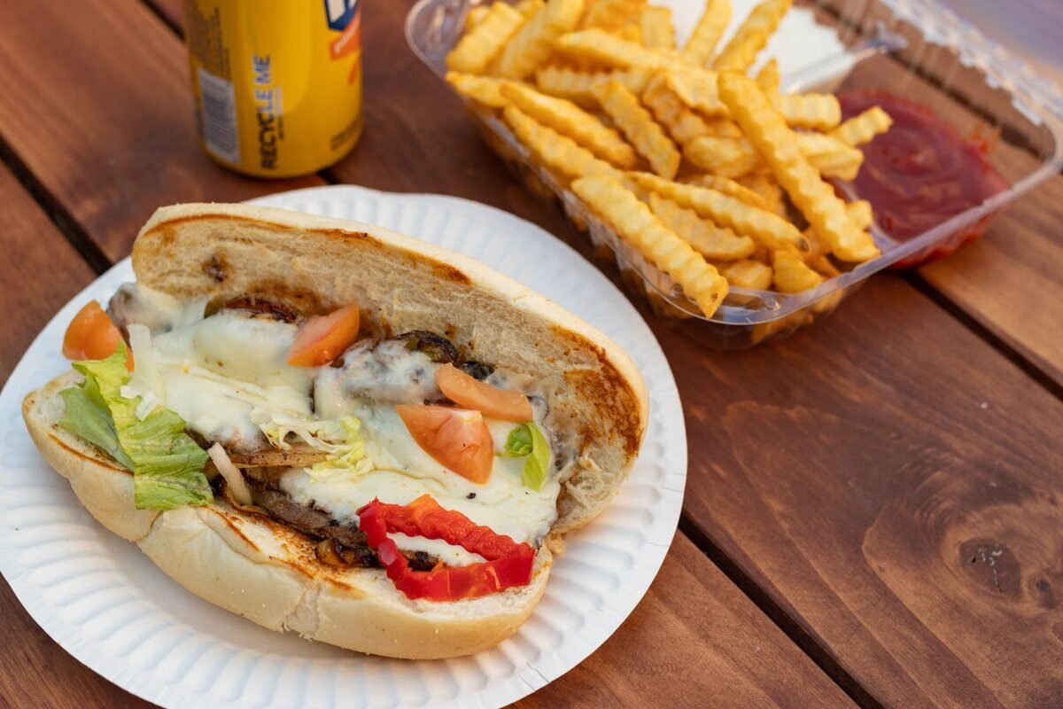 Philly cheese steak meal with fries and a drink